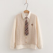 Bộ 3 món áo gile len cardigan thêu chữ cùng sơ mi và cổ đeo cà vạt.