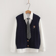 Bộ 3 món áo gile len cardigan thêu chữ cùng sơ mi và cổ đeo cà vạt.