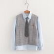 Bộ 3 món áo gile len cardigan thêu chữ cùng sơ mi và cổ đeo cà vạt.