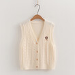 Bộ 3 món áo gile len cardigan thêu chữ cùng sơ mi và cổ đeo cà vạt.